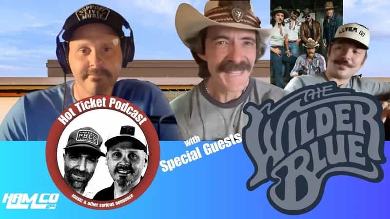 HamCo Live host Josh Cecil on a video call with two members of The Wilder Blue, beside the band's logo and a Hot Ticket Podcast badge