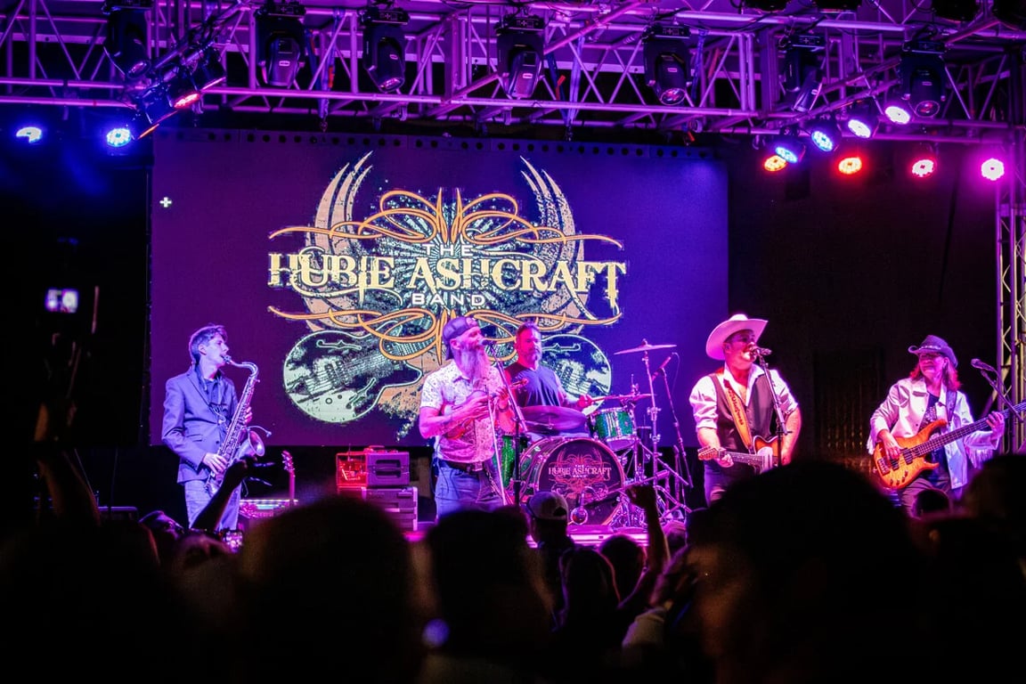 The Hubie Ashcraft Band performs under purple stage lights at the 2026 Cruise-In Concert in Auburn, Indiana