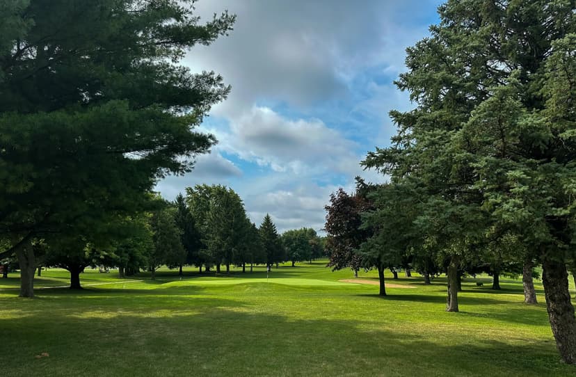 Tree-lined fairway leading to a green at Benton County Golf Course in Fowler, Indiana