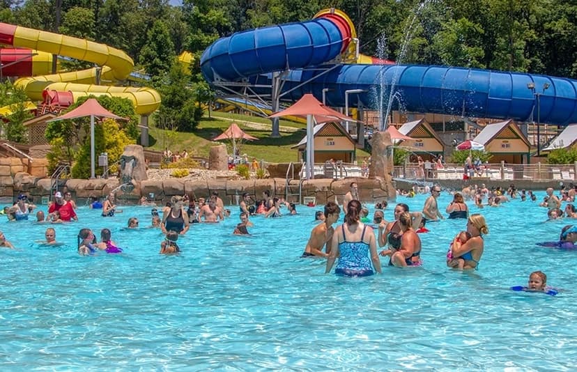 Crowds enjoy a wave pool and tall water slides at a Southern Indiana water park