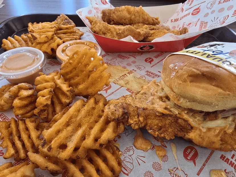 A tray of crispy chicken tenders, a sandwich, and waffle fries at The Burger Poet in Franklin, Indiana