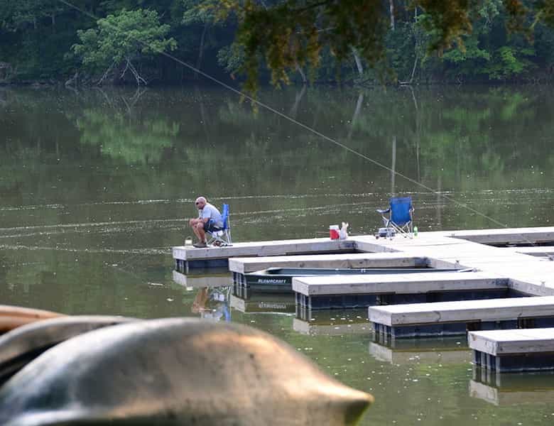 Man fishing from the floating docks on the lake at Whitewater Memorial State Park near Liberty