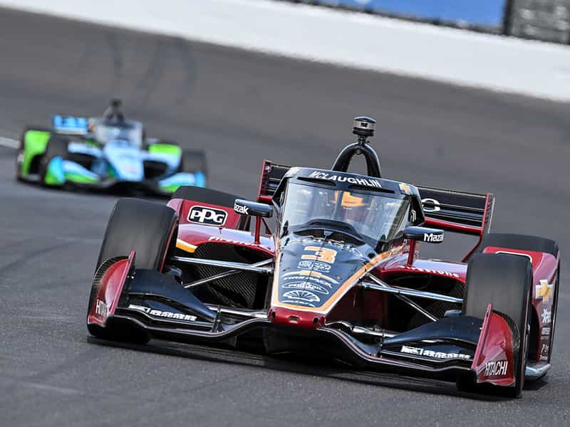 An IndyCar racing at the Indianapolis Motor Speedway