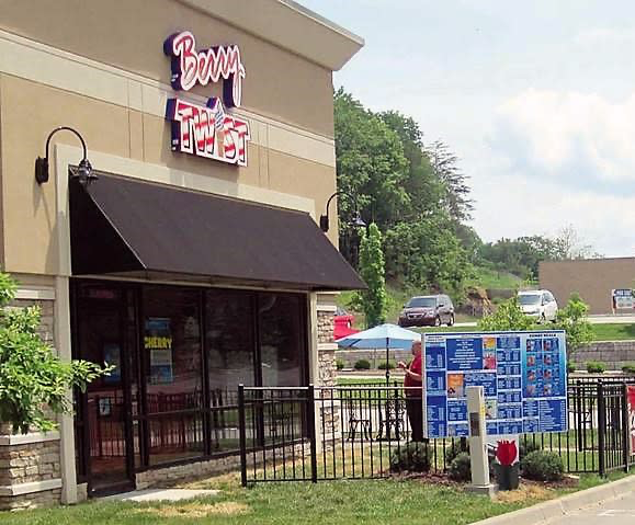 The Berry Twist ice cream shop storefront in Floyds Knobs, Indiana, with its red sign, dark awning, and outdoor menu boards.