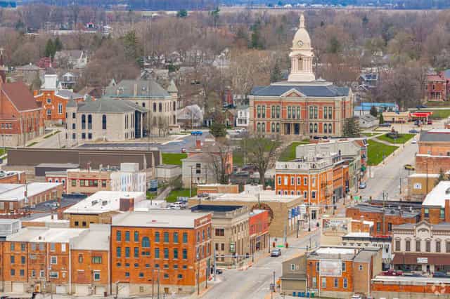 Aerial view of downtown Wabash, Indiana, centered on the domed Wabash County Courthouse and surrounded by brick storefronts and tree-lined streets.