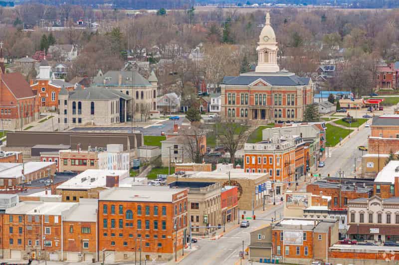Aerial view of downtown Wabash, Indiana, centered on the domed Wabash County Courthouse and surrounded by brick storefronts and tree-lined streets.