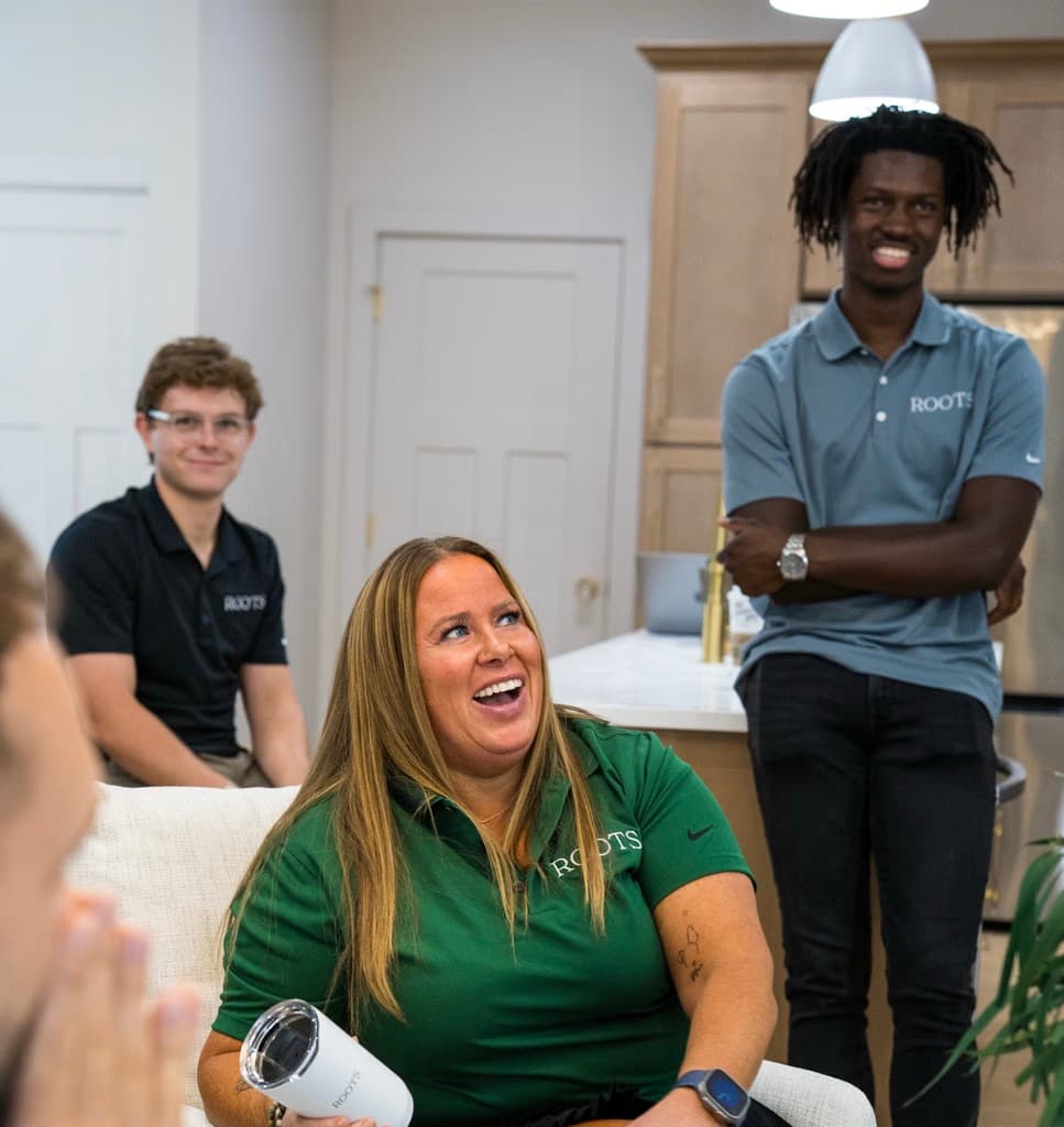 Roots agents laughing together at a team event