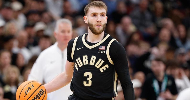 Braden Smith in a black Purdue number 3 jersey dribbling the ball up the court during a game