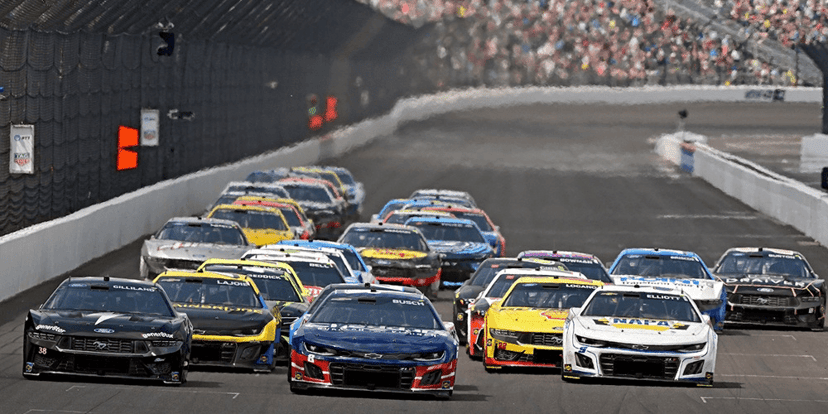 NASCAR stock cars race through a turn at the Indianapolis Motor Speedway during the Brickyard 400