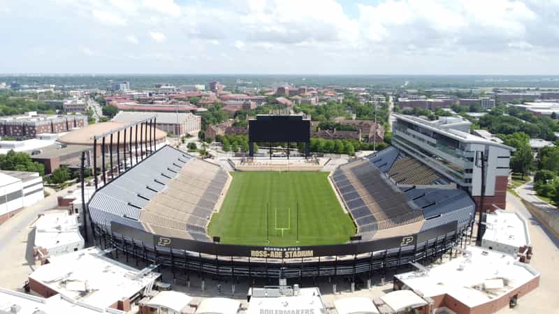 Aerial view of Ross-Ade Stadium in West Lafayette, looking across the empty Rohrman Field bowl toward the PURDUE video board and campus