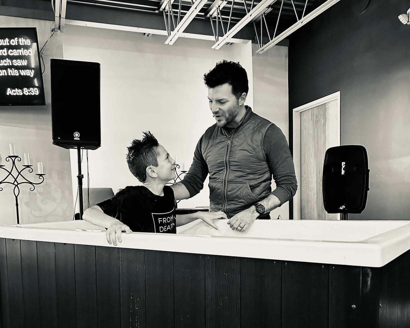 Pastor Dwayne Gibbs baptizes a young person at The District Church
