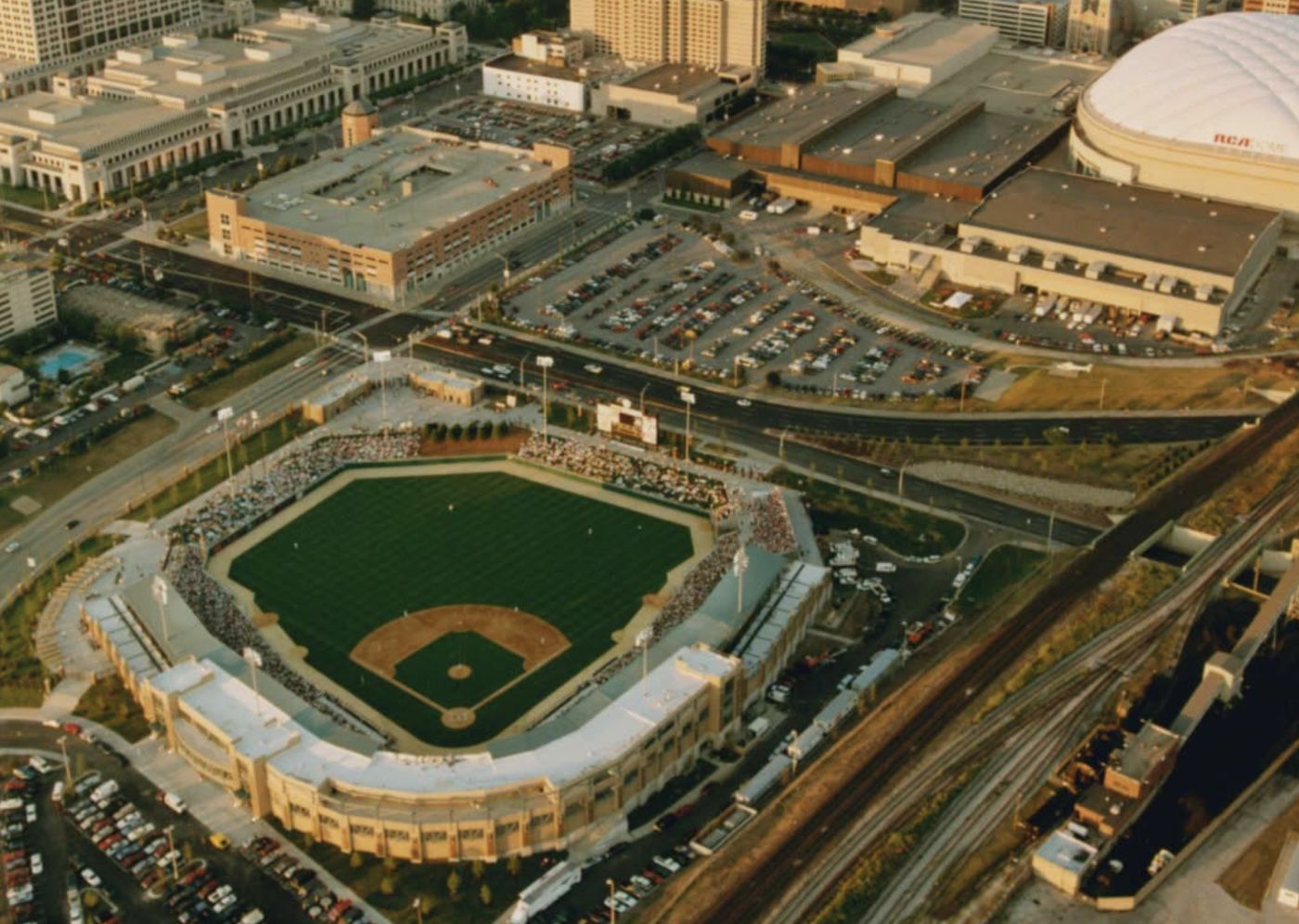 Aerial view of Victory Field packed with fans for its first Indianapolis Indians game on July 11, 1996, with parking lots, rail lines and the RCA Dome in downtown Indianapolis behind it