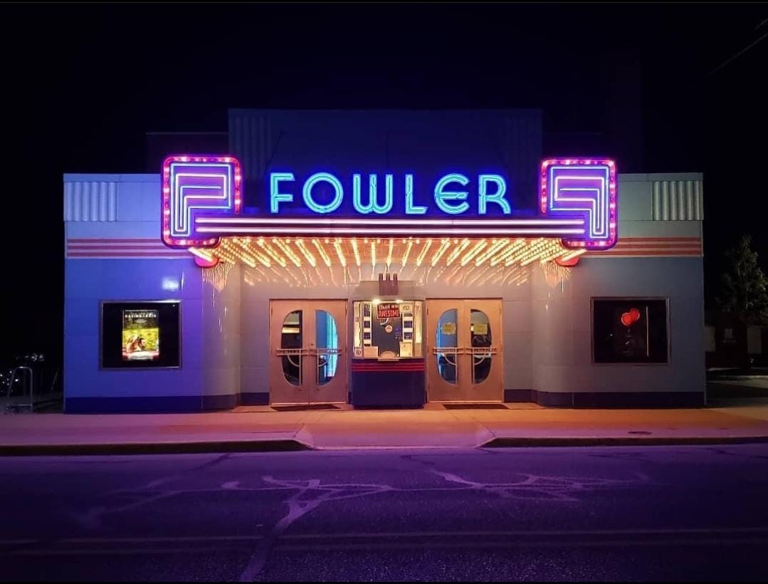 Fowler Theatre's neon marquee and Art Deco facade lit up at night in downtown Fowler, Indiana
