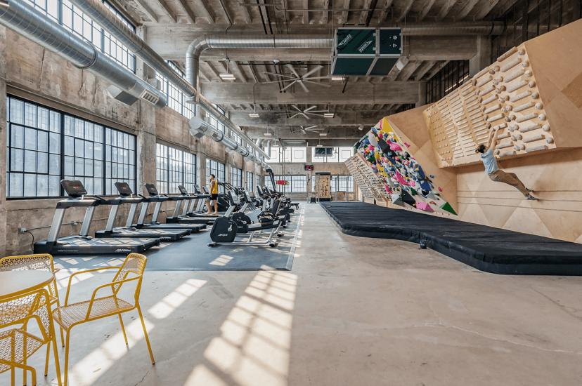 Treadmills and a climbing wall inside North Mass Boulder in Indianapolis