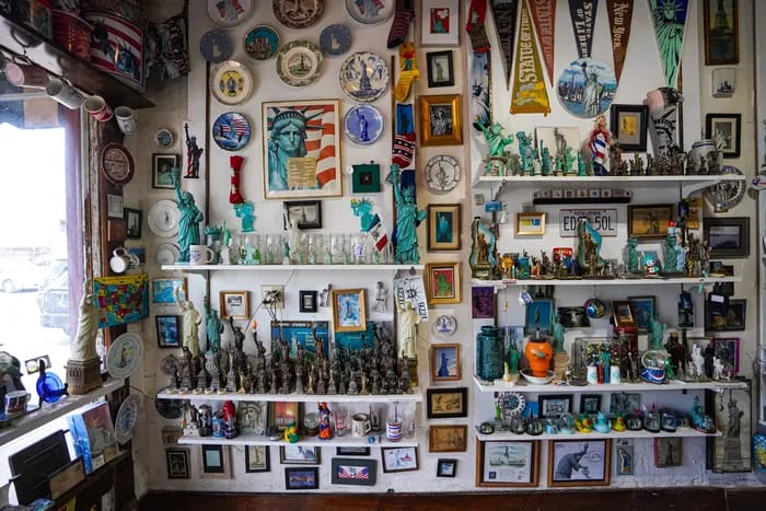 Walls and shelves crowded with Statue of Liberty replicas, souvenir plates, pennants and framed prints inside the Teeny Statue of Liberty Museum in Indianapolis