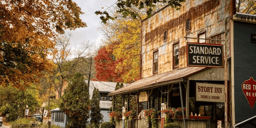 Story Inn general store building with a Standard Service sign among fall trees