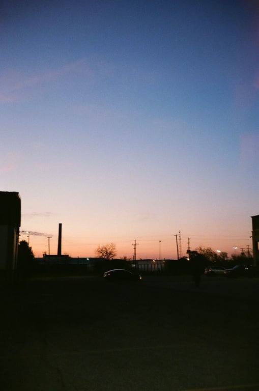 Image: Smokestack viewed at sunset from the Kroc Center parking lot