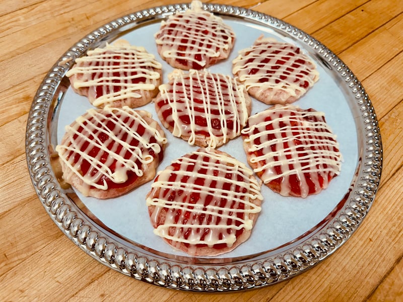 The new Berry Cheesecake Cookie at Illinois St Food Emporium, topped with berry jam and white chocolate drizzle