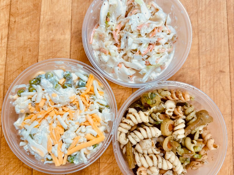 Deli sides by the pound at Illinois St Food Emporium: coleslaw, pea salad, and pasta salad