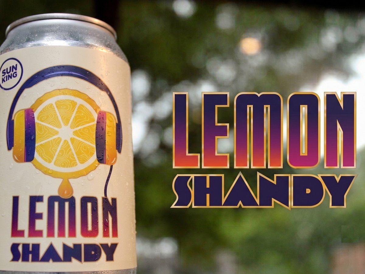 A cold can of Sun King Lemon Shandy beside the Lemon Shandy wordmark.