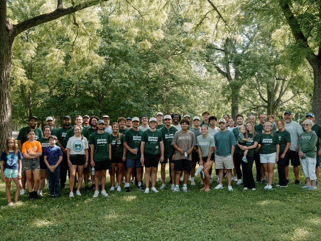 Dozens of Street Sweep volunteers gathered under the trees before heading out