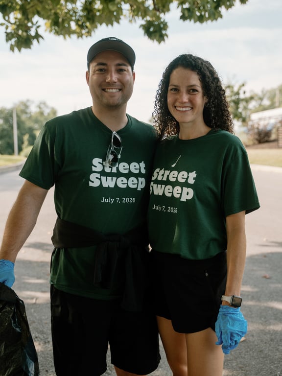A couple in matching Street Sweep tees ready to volunteer