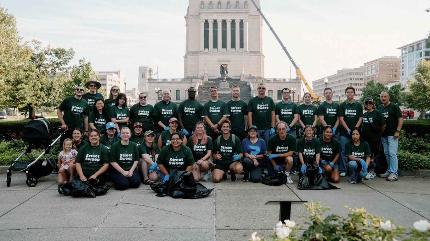 The Street Sweep crew gathered in front of the Indiana World War Memorial