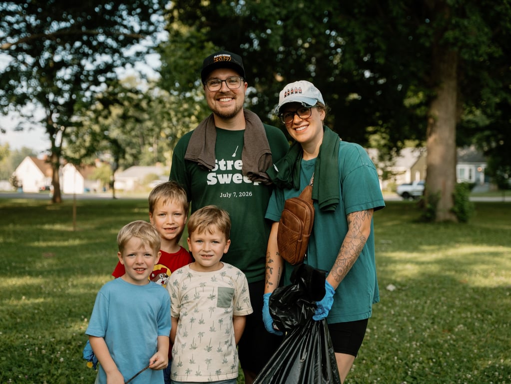 A family with young kids in Street Sweep tees at a neighborhood park