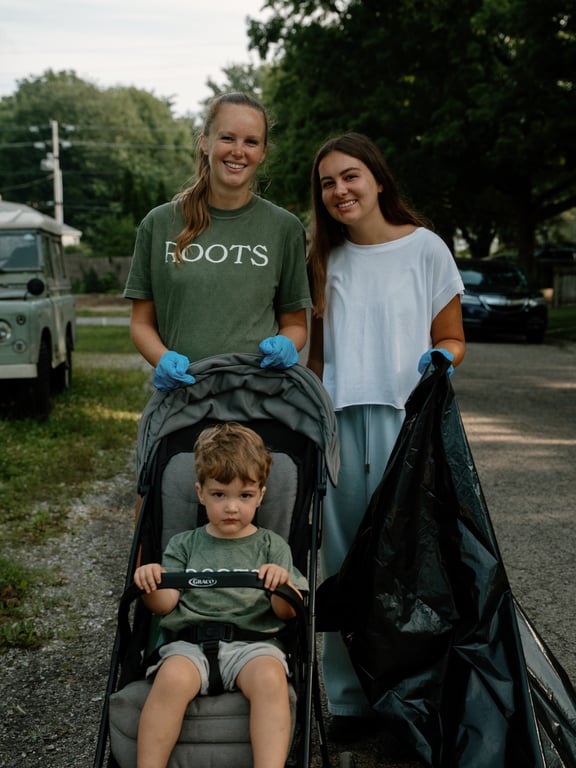 A mom, a teen volunteer, and a toddler in a stroller ready for the sweep