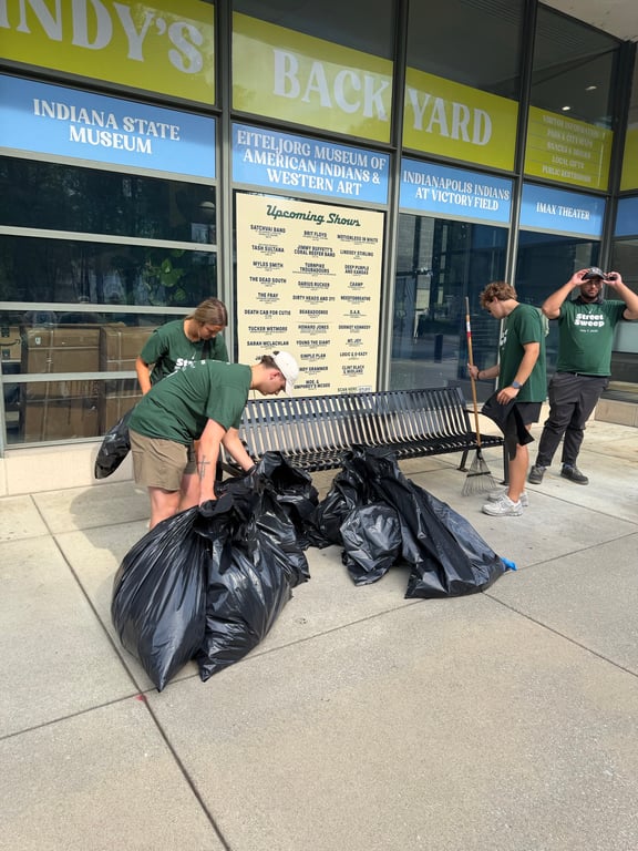 Volunteers bagging trash outside the Indiana State Museum