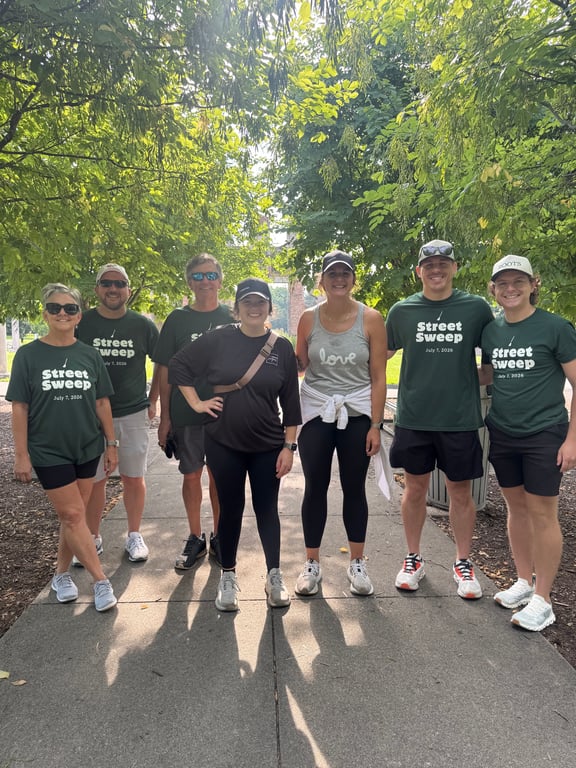 A Street Sweep crew on a tree-lined downtown path