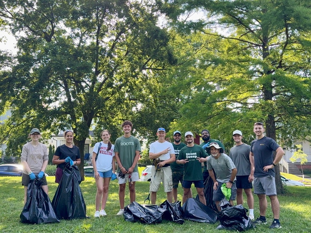 Volunteers with full trash bags after a neighborhood cleanup