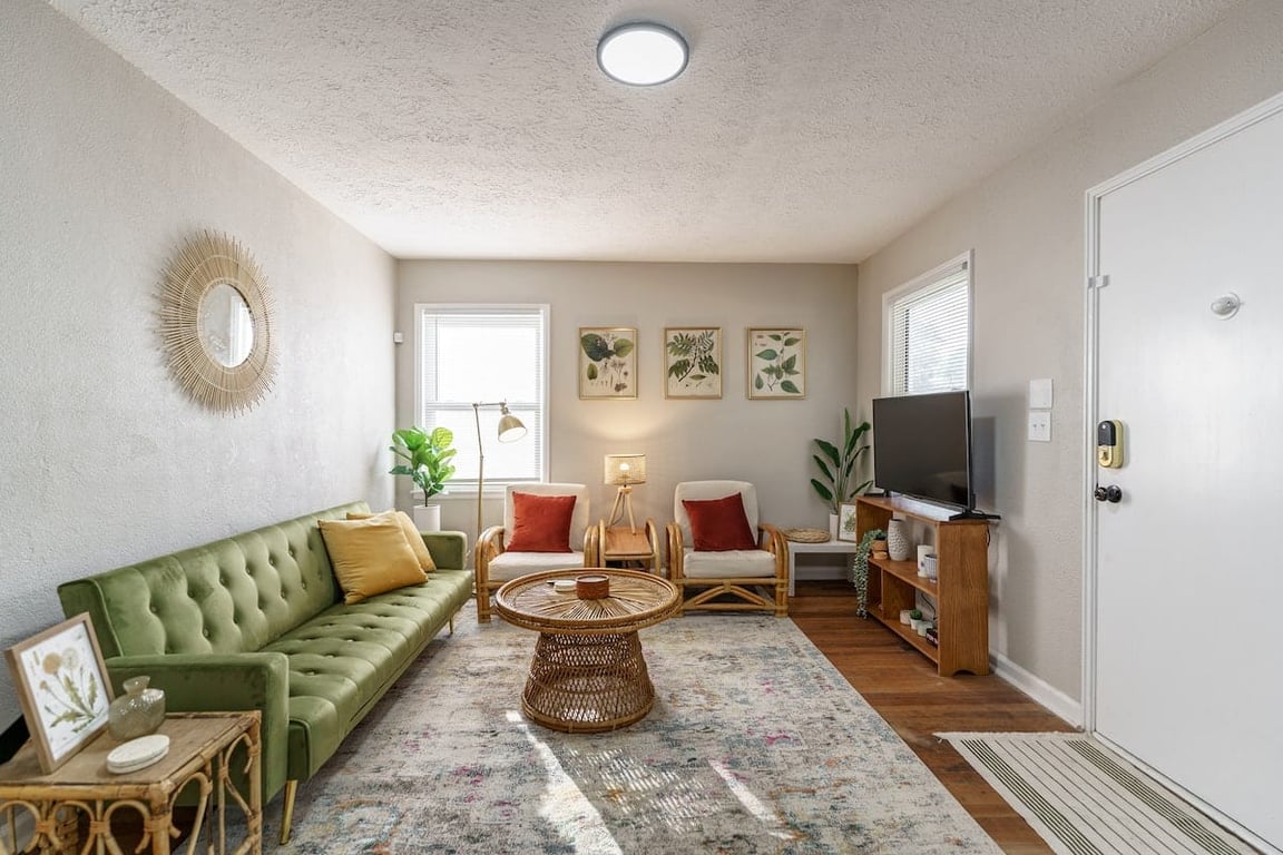 4658 Farrington Avenue, furnished living room with a green sofa and rattan chairs