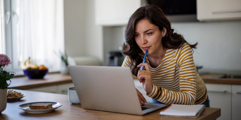 a woman applying for a Schengen visa on her laptop at home