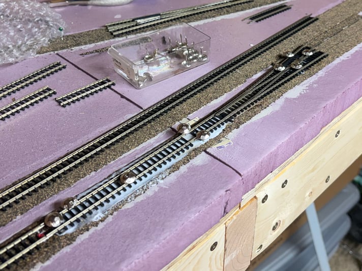 The first switch being glued down, Day 16 of track work