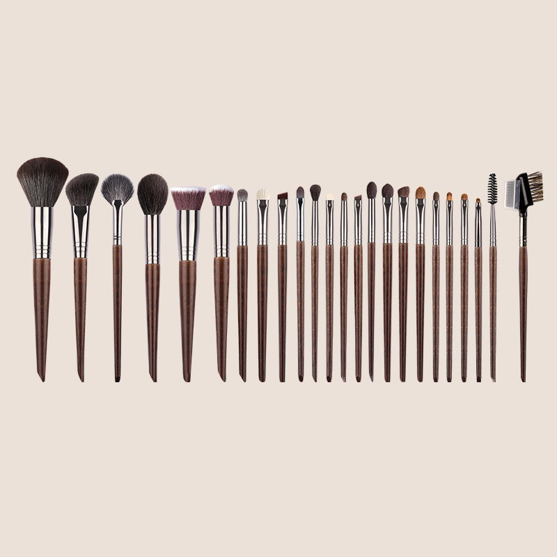All 24 brushes set out by size with the roll-up case