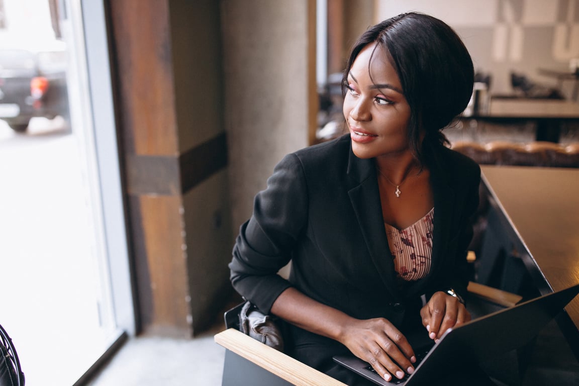 A woman sitting at the desk with a laptop