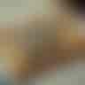 An AI-generated image of a tan manilla folder closed, laying on top of random sheet music, with the words "JUDOSCALE BOP" on the front