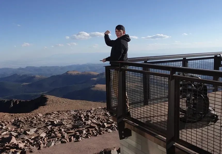 Sam Primeaux, Meauxbility founder, at Pikes Peak celebrating recovery and mobility independence