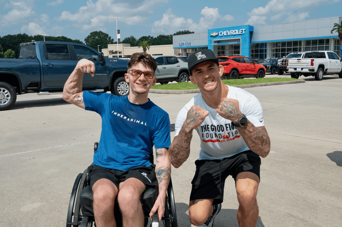 Sam Primeaux and Dustin Poirier from The Good Fight Foundation at a backpack drive event 2025