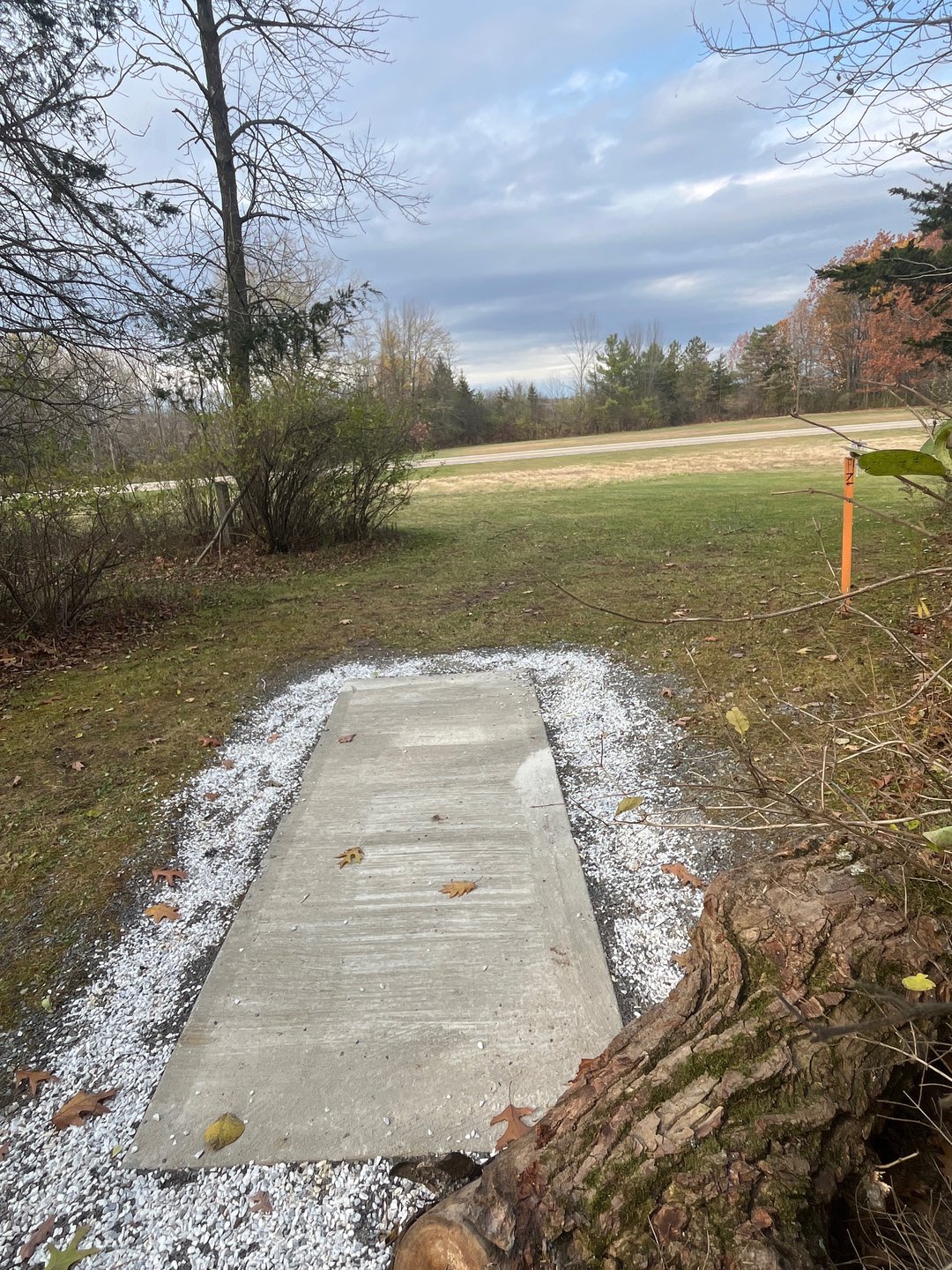 Tee 7. Basket to left around corner. Shortcuts not permitted. Must go around.