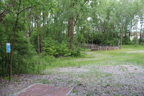 #16: Slight hyzer over OB campfire area. Touchy green to land on. Easy to come up short or go deep.