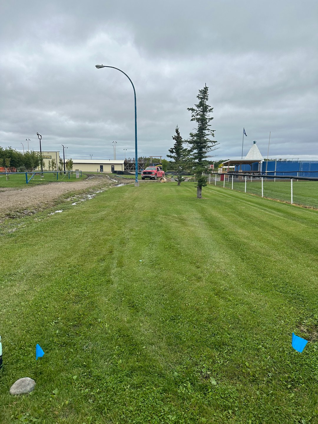 Hole 1  found by the pickle ball course. 

Rule for the hole Beyond road and beyond fence are out of bound. 

For added difficulty: mandatory right of light post and left second tree. Missed mando advances to light post for drop zone with added stroke penalty. 