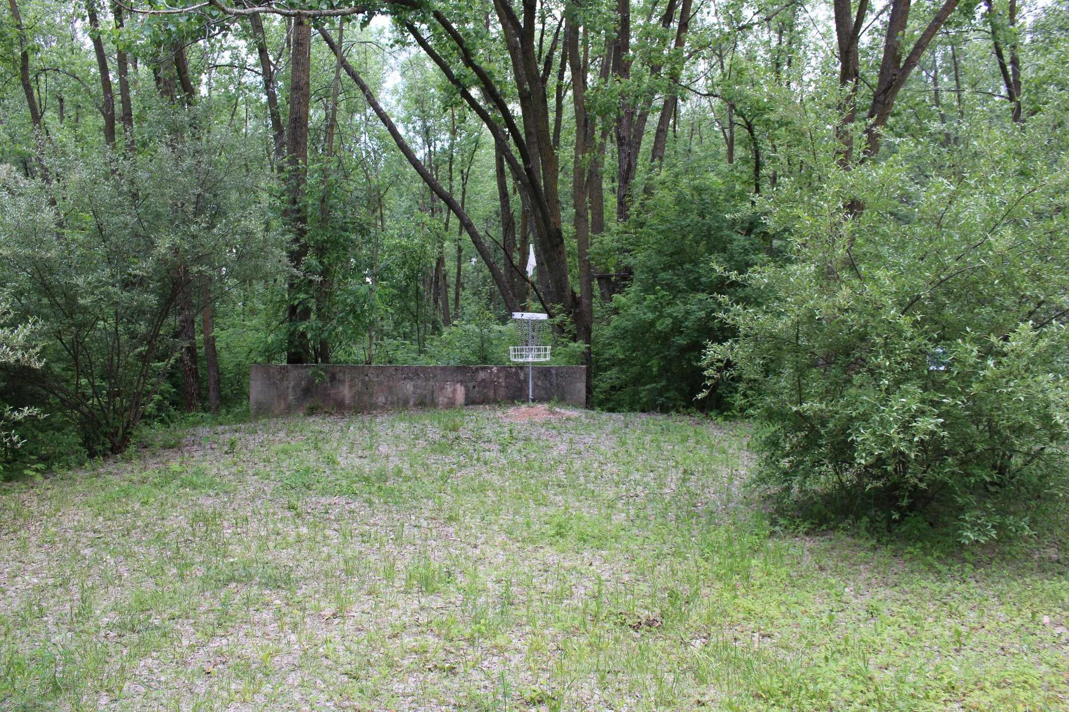 #7: Basket with drop off behind cement wall.