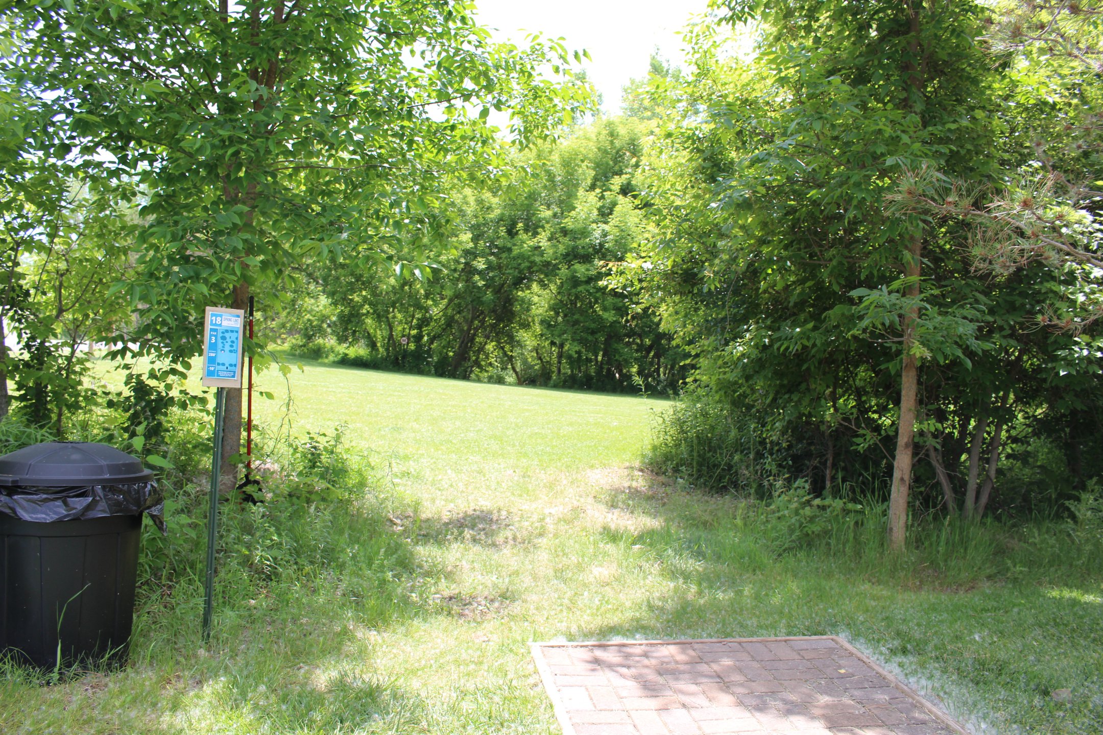 #18: Blind left to right downhill through a tight gap. Mando on the left prevents throwing around into practice basket area.