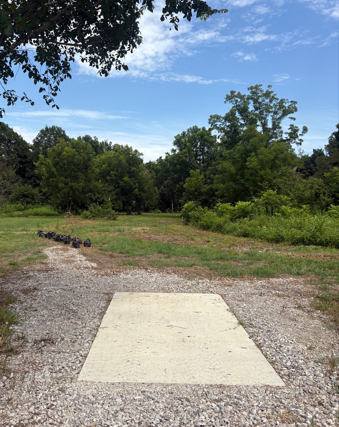 The baskets just down there around the corner to the right.  Coal Creek lurks deep and right of the green.  