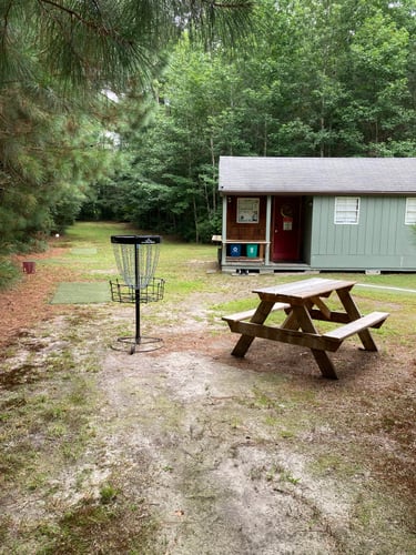 Hole 1 tee pads , practice basket and clubhouse 