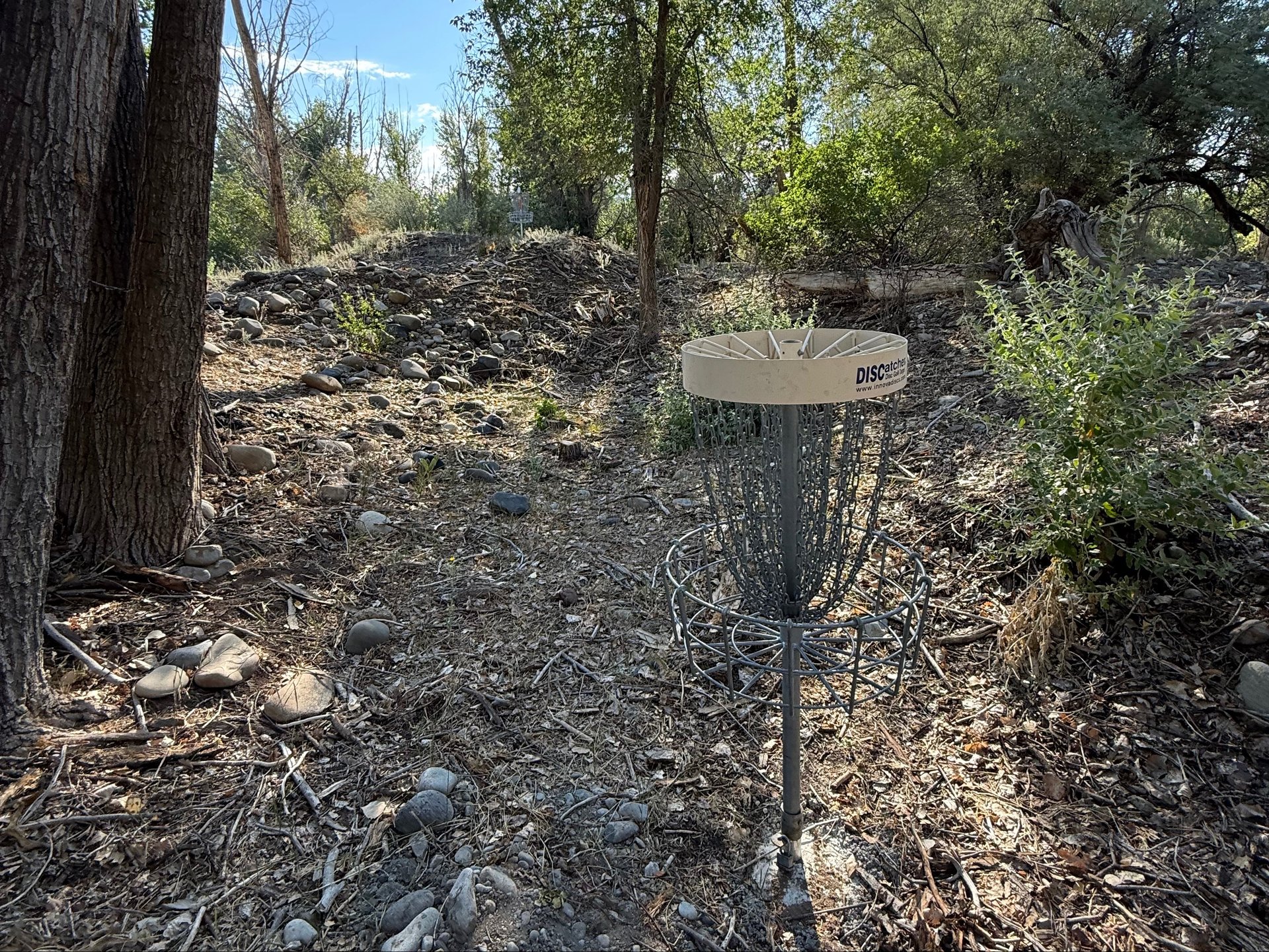 The short basket in the hollow and the long basket on top of the mound.
