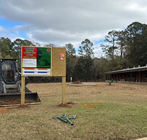 Albany Georgia Marine Base course map and rules sign, with space to post information.   Tee 1 in background. 