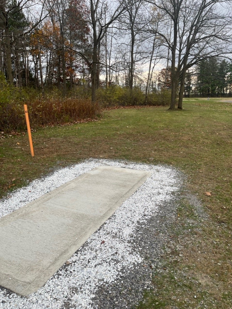 Tee 13. Basket around corner to the left. Do NOT throw across road.